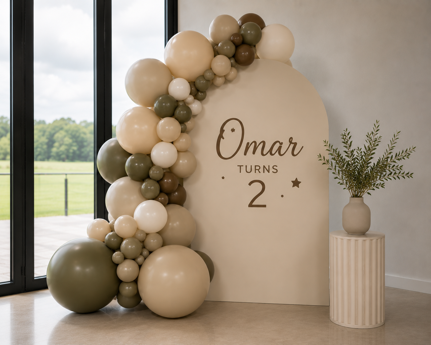 Rose and Rae cream arch and balloon garland styled for Omar's second birthday