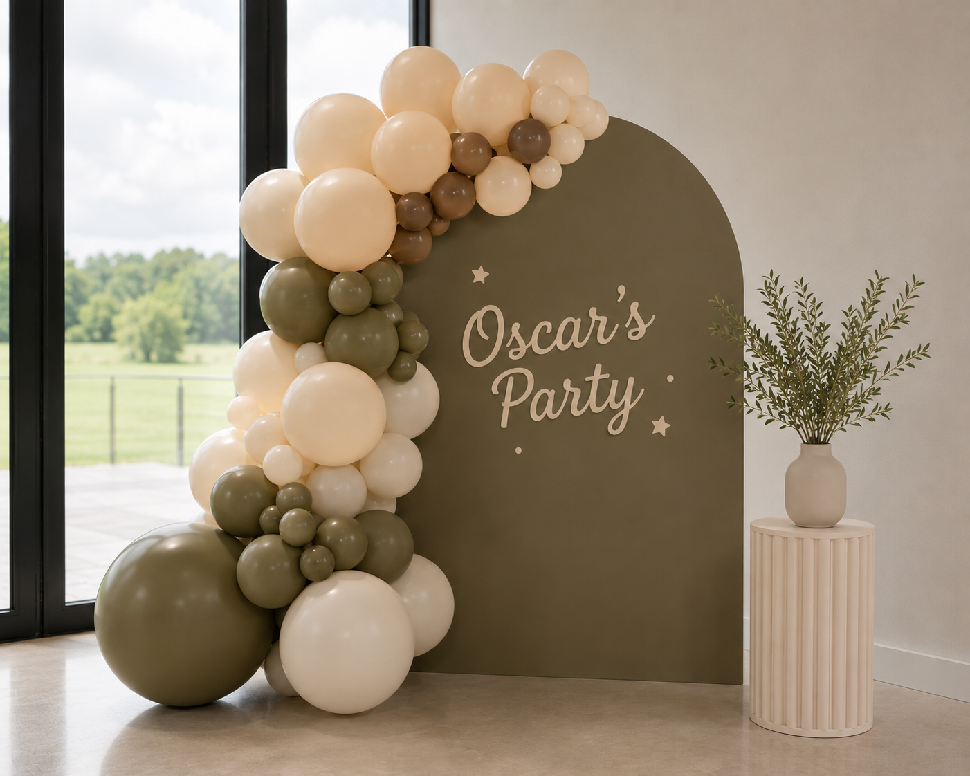 Rose and Rae olive arch and balloon garland styled for Oscar's party